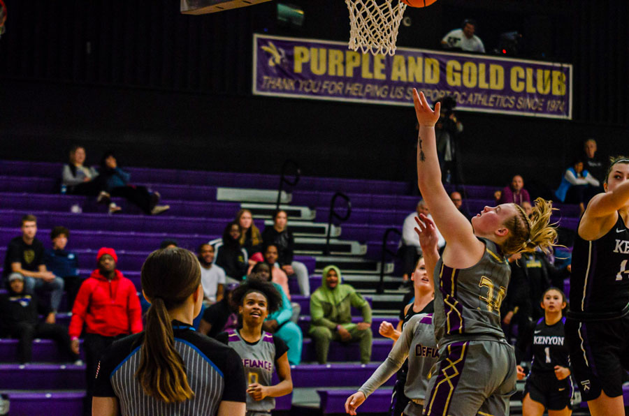 Defince College Player going for a lay up